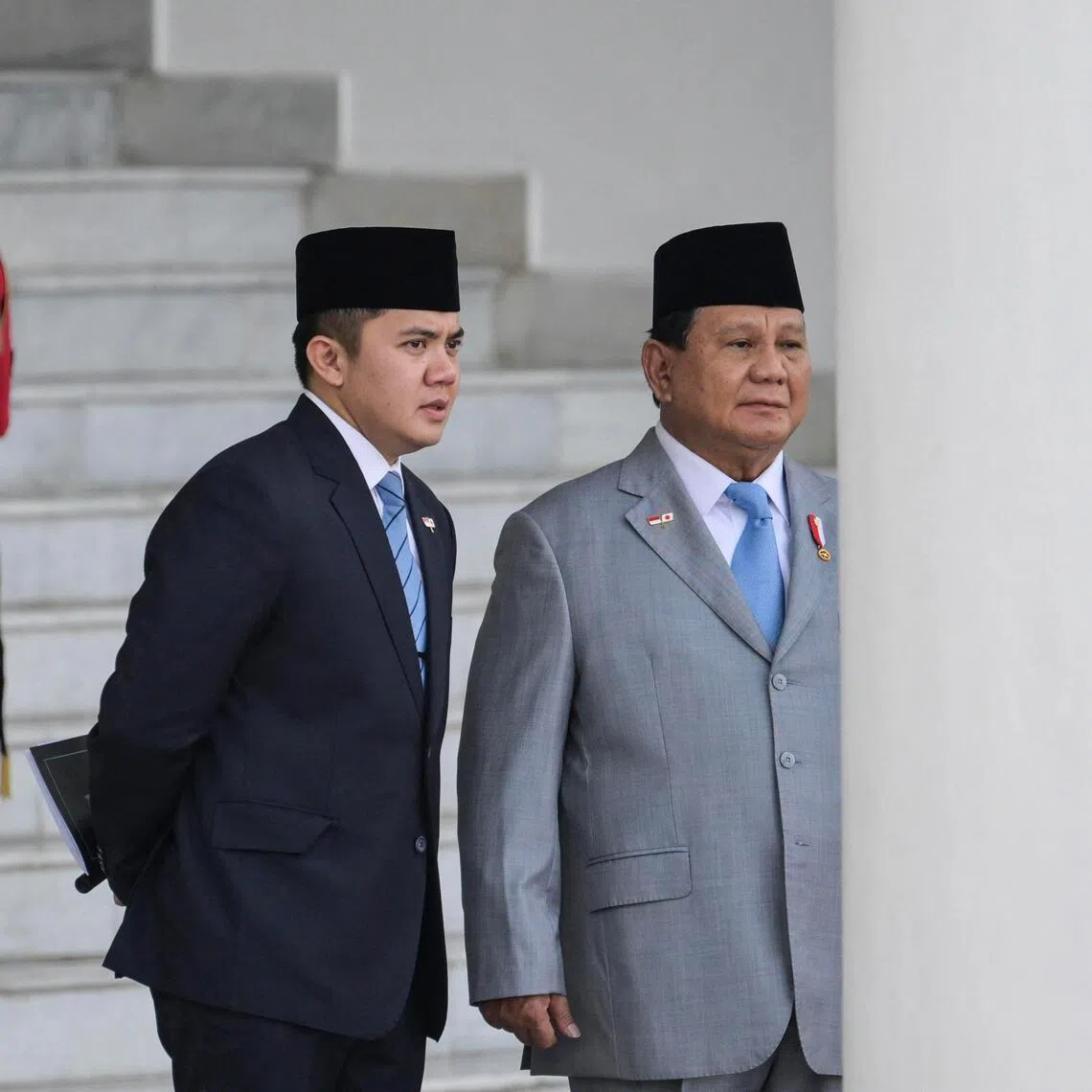 Indonesia's President Prabowo Subianto (R) and his Cabinet Secretary Teddy Indra Wijaya (C) wait for the arrival Japan's Prime Minister Shigeru Ishiba at the presidential palace in Bogor, West Java, on January 11, 2025. (Photo by BAY ISMOYO / AFP)