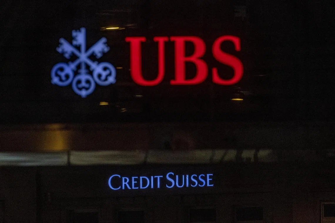 Logos of Swiss banks UBS and Credit Suisse are seen on an office building in Zurich, Switzerland March 19, 2023. REUTERS/Denis Balibouse