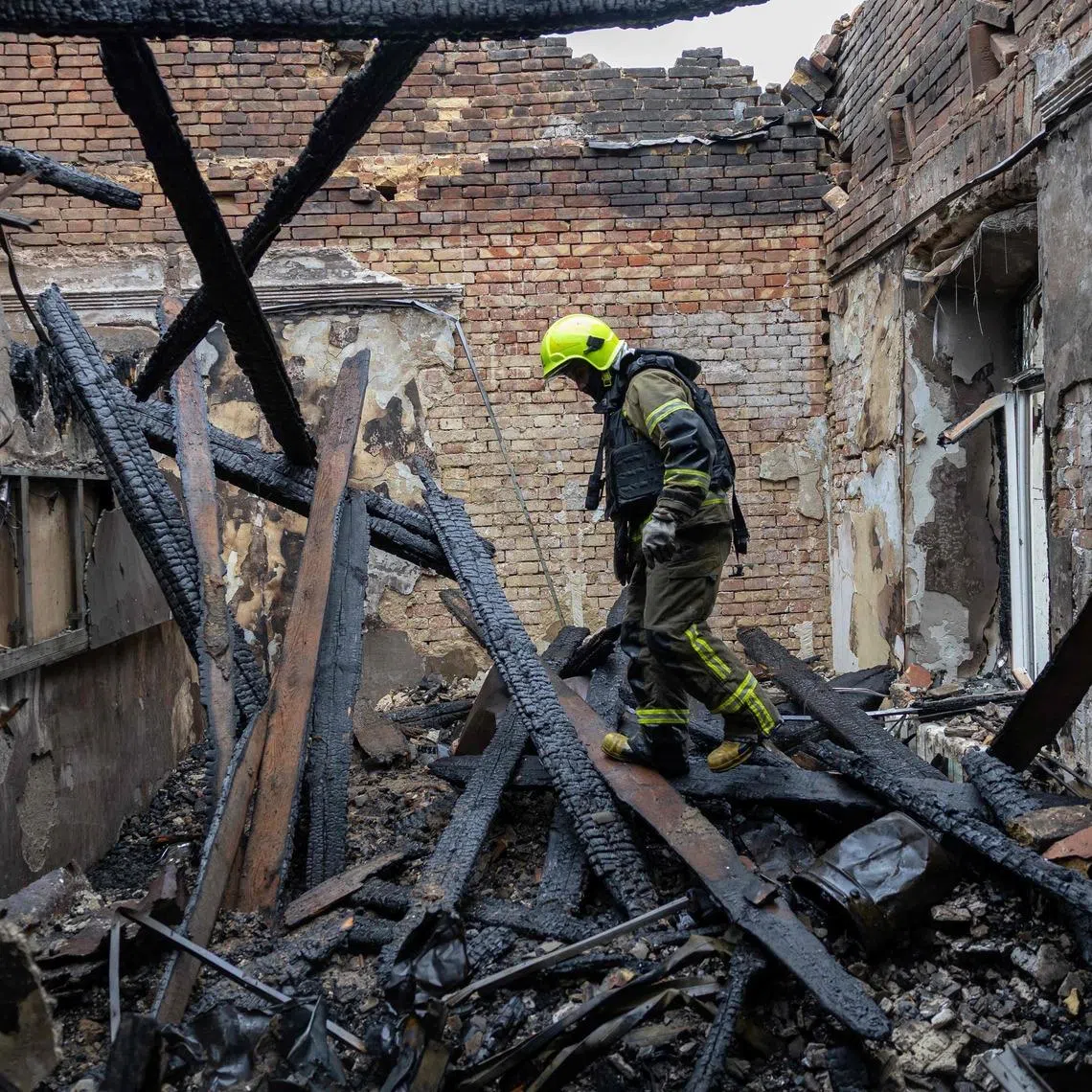 A Ukrainian rescuer at the site of an air attack in Odesa on May 18. Officials said Russia launched strikes at Ukraine overnight, hitting residential buildings, a school and a kindergarten in Odesa.