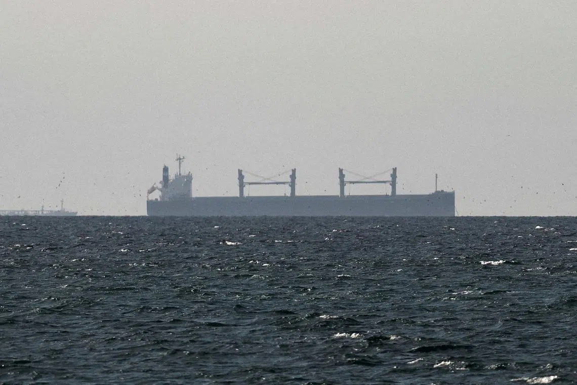 FILE PHOTO: A cargo ship in the Gulf, near the Strait of Hormuz, as seen from northern Ras al-Khaimah, near the border with Oman’s Musandam governance, amid the U.S.-Israeli conflict with Iran, in United Arab Emirates, March 11, 2026. REUTERS/Stringer/File Photo/File Photo