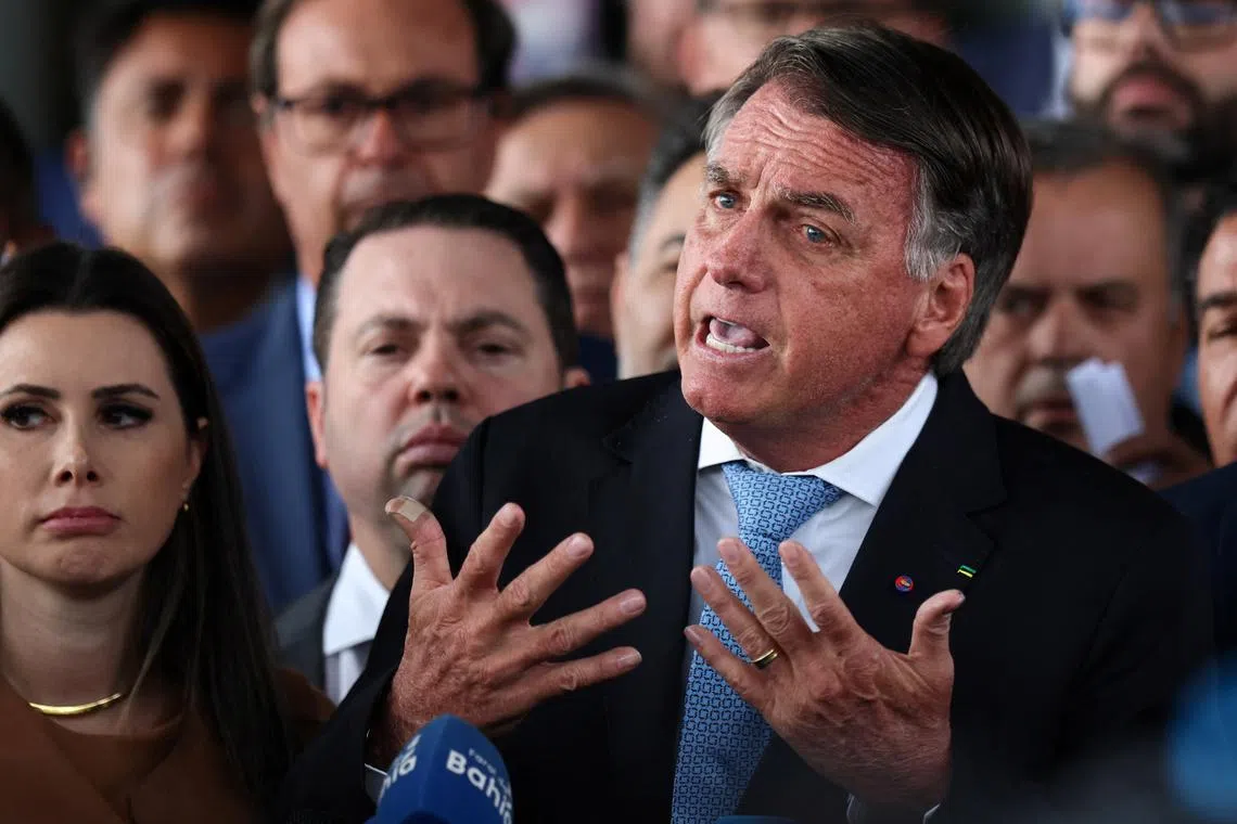Former Brazilian President Jair Bolsonaro talks to the media, after the Supreme Court voted that he should stand trial for allegedly attempting a coup after his 2022 electoral defeat, in Brasilia, Brazil, March 26, 2025. REUTERS/Adriano Machado