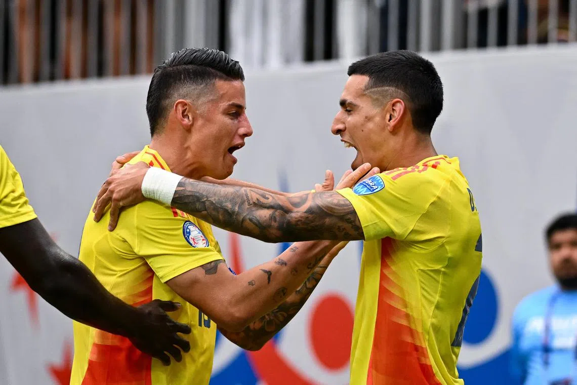 Jun 24, 2024; Houston, TX, USA; Colombia full-back Daniel Munoz (21) is congratulated by midfielder James Rodriguez (10) after scoring a goal during the first half against Paraguay at NRG Stadium. Mandatory Credit: Maria Lysaker-USA TODAY Sports