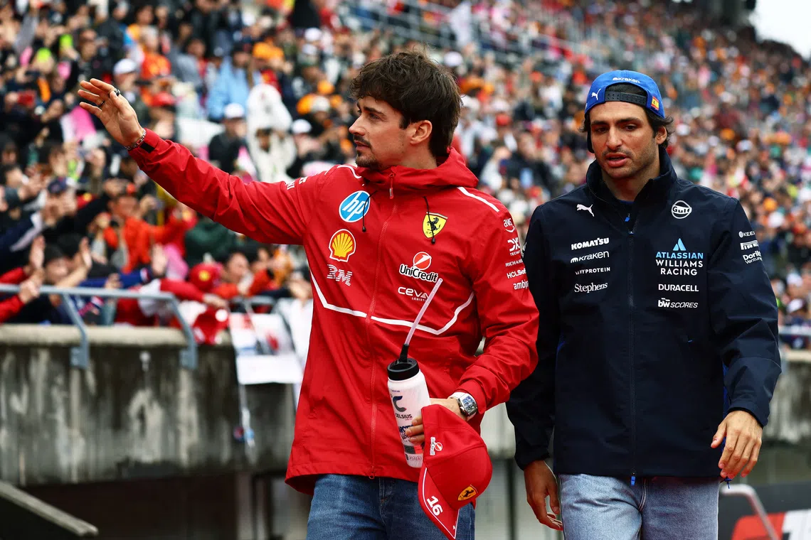 FILE PHOTO: Formula One F1 - Japanese Grand Prix - Suzuka Circuit, Suzuka, Japan - April 6, 2025 Ferrari's Charles Leclerc waves to the crowd during the drivers parade before the race as Williams' Carlos Sainz Jr. looks on REUTERS/Issei Kato/File Photo