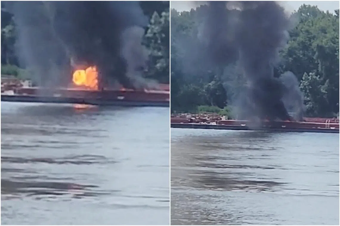 Smoke rises after a helicopter crashed into a barge on the Mississippi River in Alton, Illinois, on Aug 7.