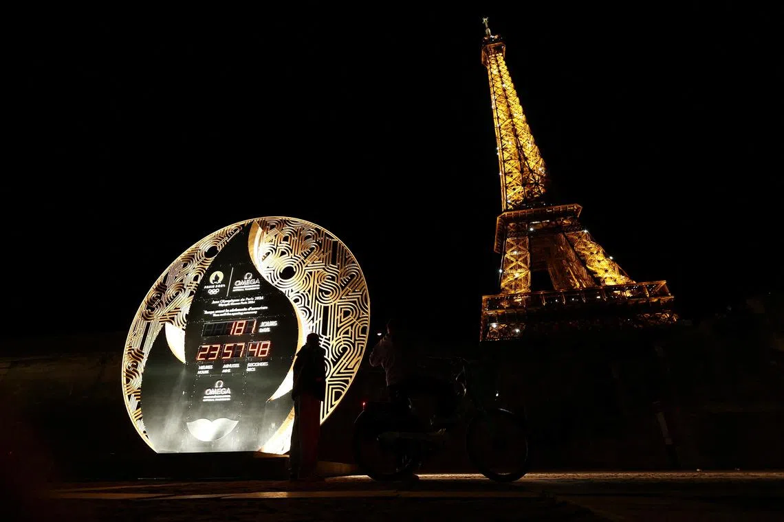 With six months to go until the start of the Paris 2024 Olympics in July, the countdown clock is pictured near the Eiffel Tower.