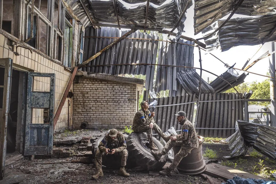 Soldiers from Ukraine’s 68th Brigade rest inside a destroyed and abandoned building on the outskirts of the recently-reclaimed village of Blahodatne.
