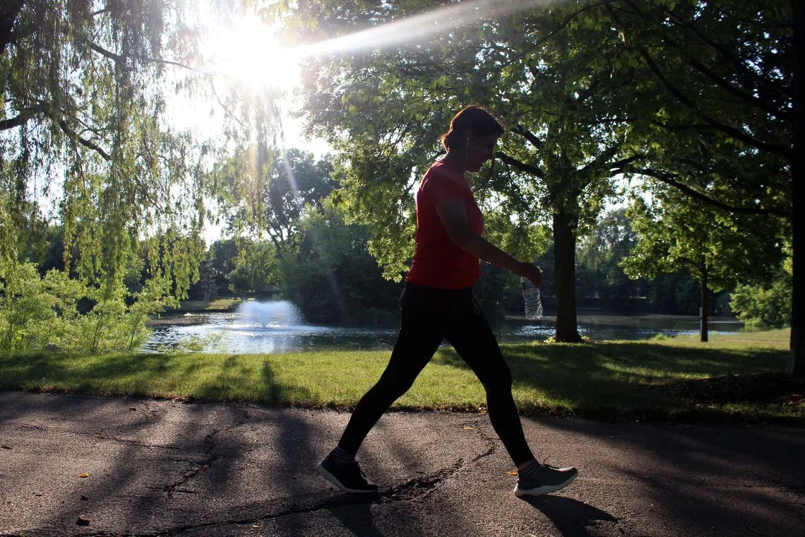 A woman walking for exercise in Illinois in the United States. In the largest study to incorporate activity tracker data, picking up the pace paid dividends for long-term health.