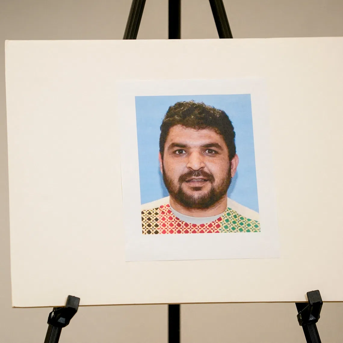 A picture of Rahmanullah Lakanwal, an Afghan national who is the suspect in the shooting of two National Guard members, is displayed at a press conference with FBI Director Kash Patel, attorney Jeanine Pirro and other authorities, in Washington, D.C., U.S., November 27, 2025. REUTERS/Nathan Howard