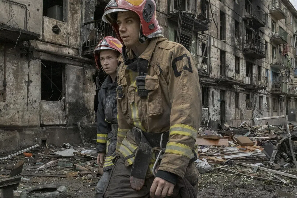 Firefighters at an apartment building hit by a Russian missile attack, in Kryvyi Rih, in central Ukraine.