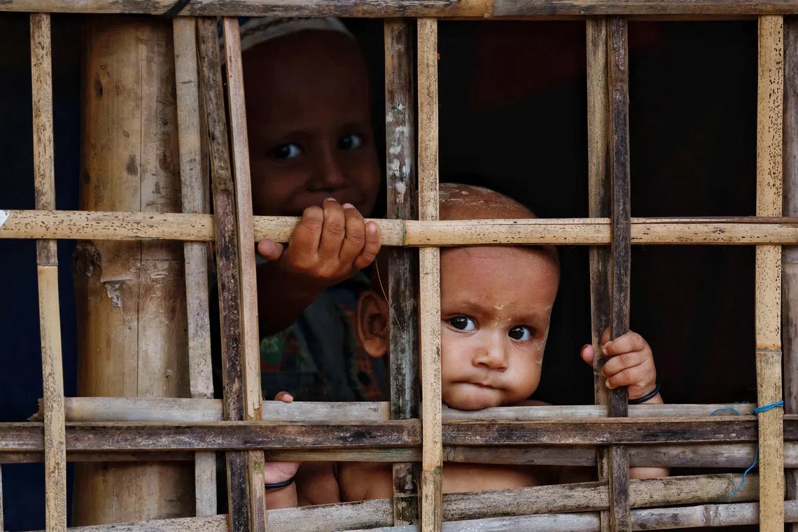FILE PHOTO: Rohingya refugee children look on from their shelter at a refugee camp, in Cox's Bazar, Bangladesh, September 28, 2024. REUTERS/Mohammad Ponir Hossain/File Photo
