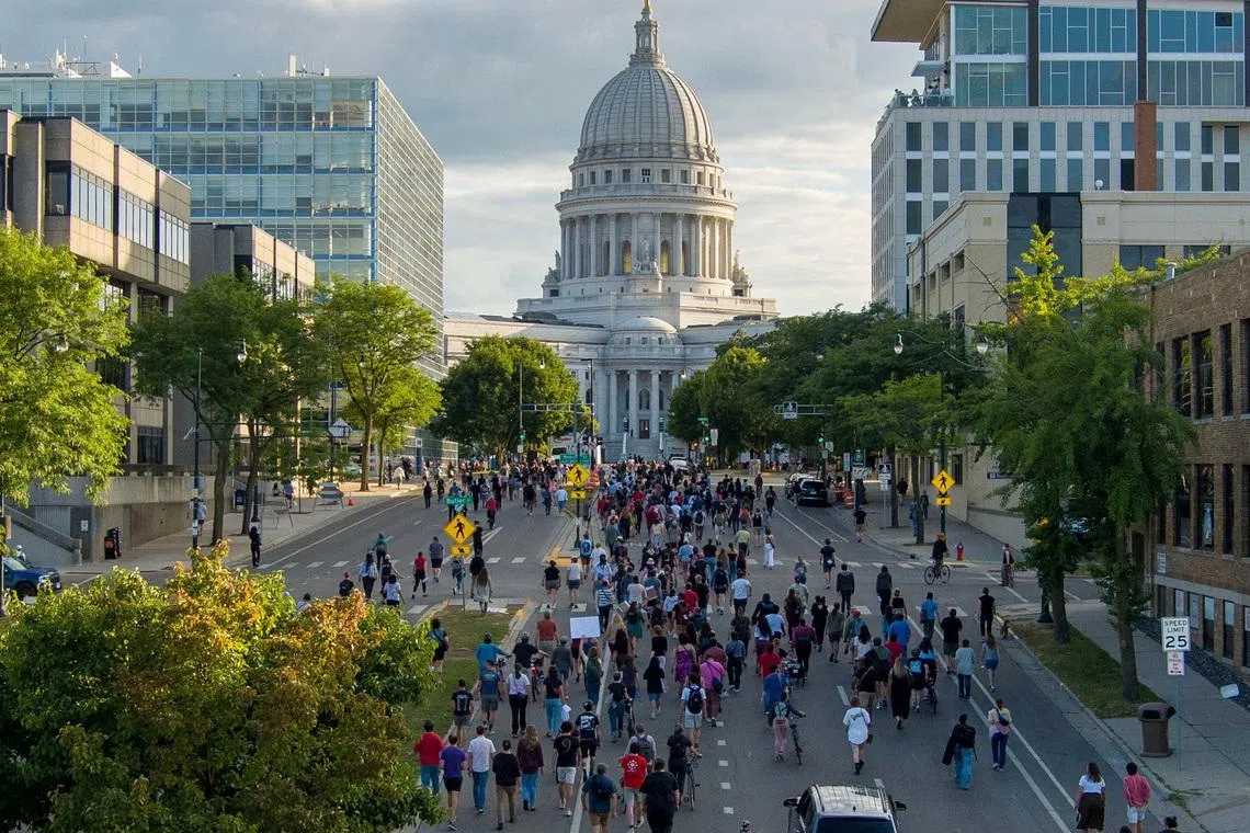 People march in protest to the Wisconsin State Capitol in response to a Madison police officer shooting and killing a man who police reported to be carrying a knife on the city’s near east side, in Madison, Wisconsin, on July 22.