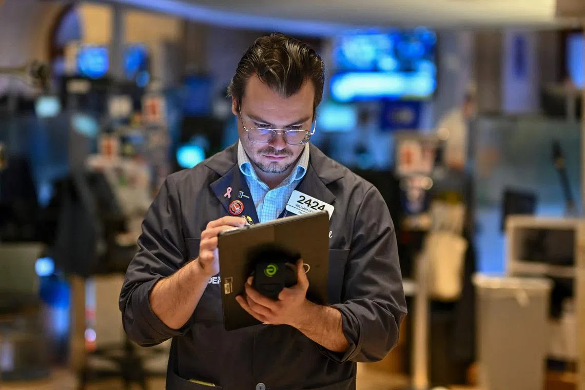 Traders work on the floor of the New York Stock Exchange, in New York City.