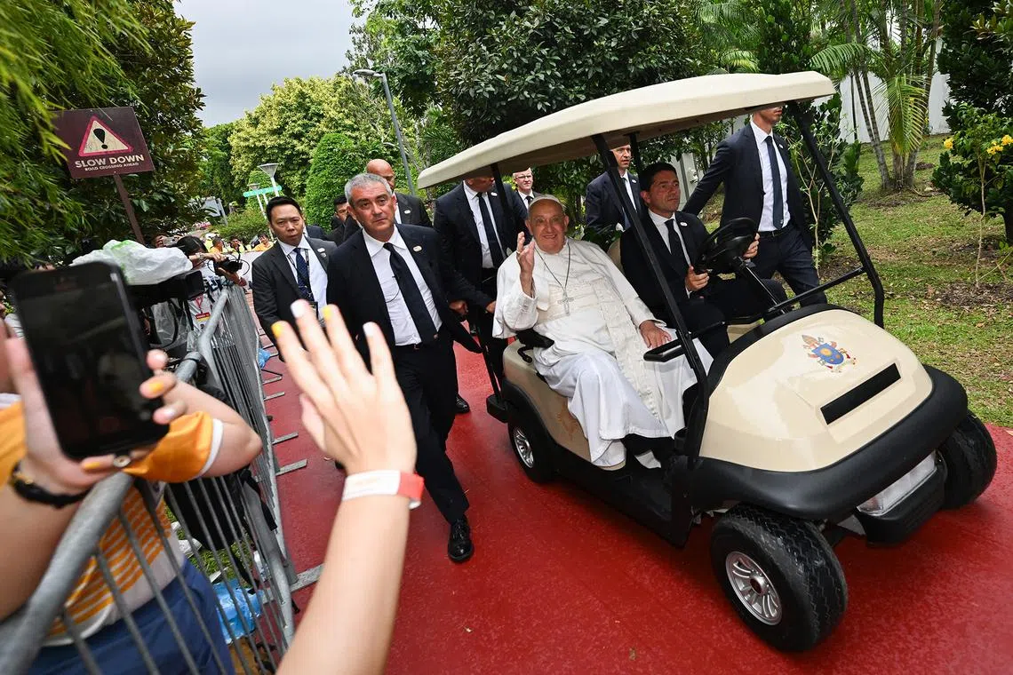 Pope Francis, the head of the worldwide Catholic Church, travelling on a buggy along Changi Airport Connector leading to Jurassic Mile on Sept 11, 2024. 