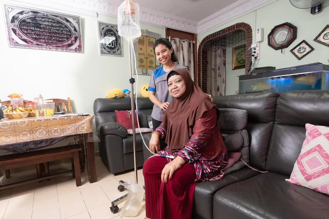 Experienced peritoneal dialysis nurses like Ms Shadirah Zaharum (left) help patients like Madam Norhyati Buang manage their condition, offer advice on living conditions and provide emotional support. 