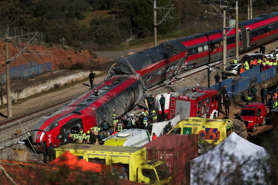 FILE PHOTO: Members of the Spanish Civil Guard, along with other emergency personnel, work next to one of the trains involved in the accident, at the site of a deadly derailment of two high-speed trains near Adamuz, in Cordoba, Spain, January 19, 2026. REUTERS/Susana Vera/File Photo