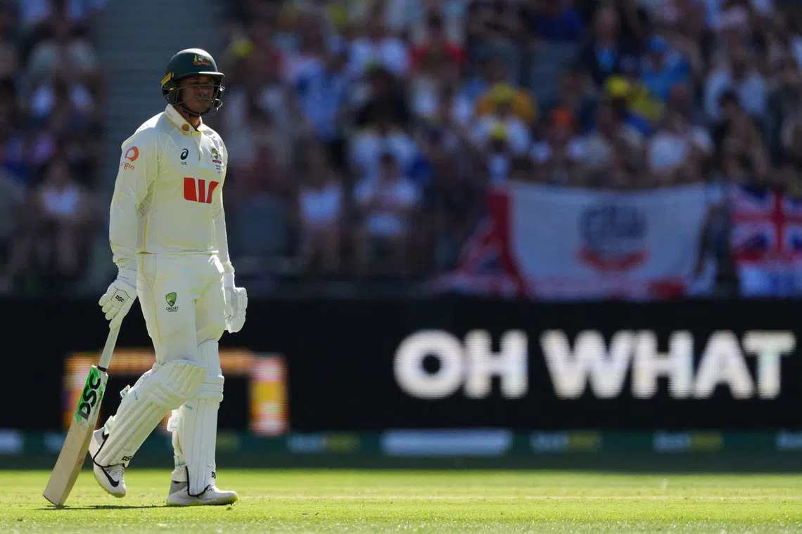 Cricket - The Ashes - Australia v England - First Test - Perth Stadium, Perth, Australia - November 21, 2025 Australia's Usman Khawaja looks dejected and walks back to the pavilion after losing his wicket, caught out by England's Jamie Smith off the bowling of Brydon Carse REUTERS/Asanka Brendon Ratnayake