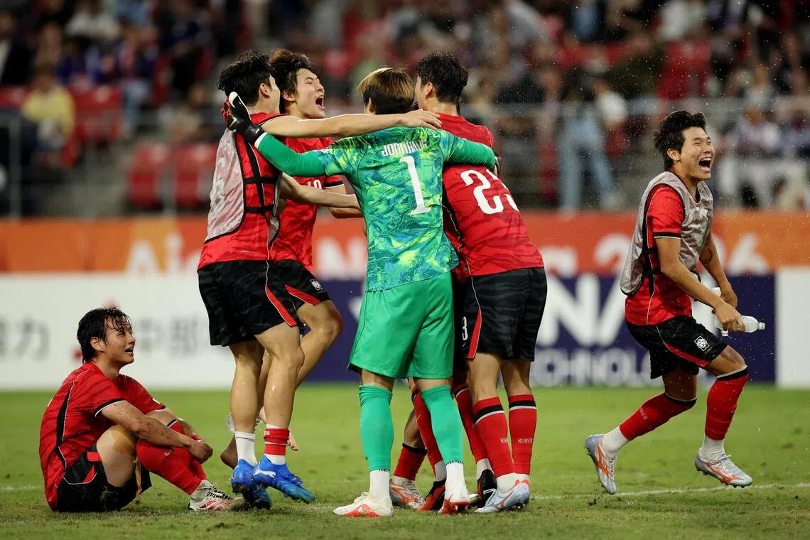 South Korea players celebrate after beating Japan 1-0 to win the Asian Games football gold medal on Oct 3.
