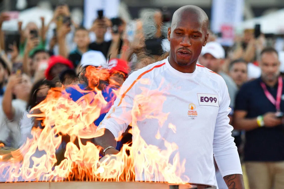 Former football player Didier Drogba lighting the cauldron, in Marseille, on May 9.
