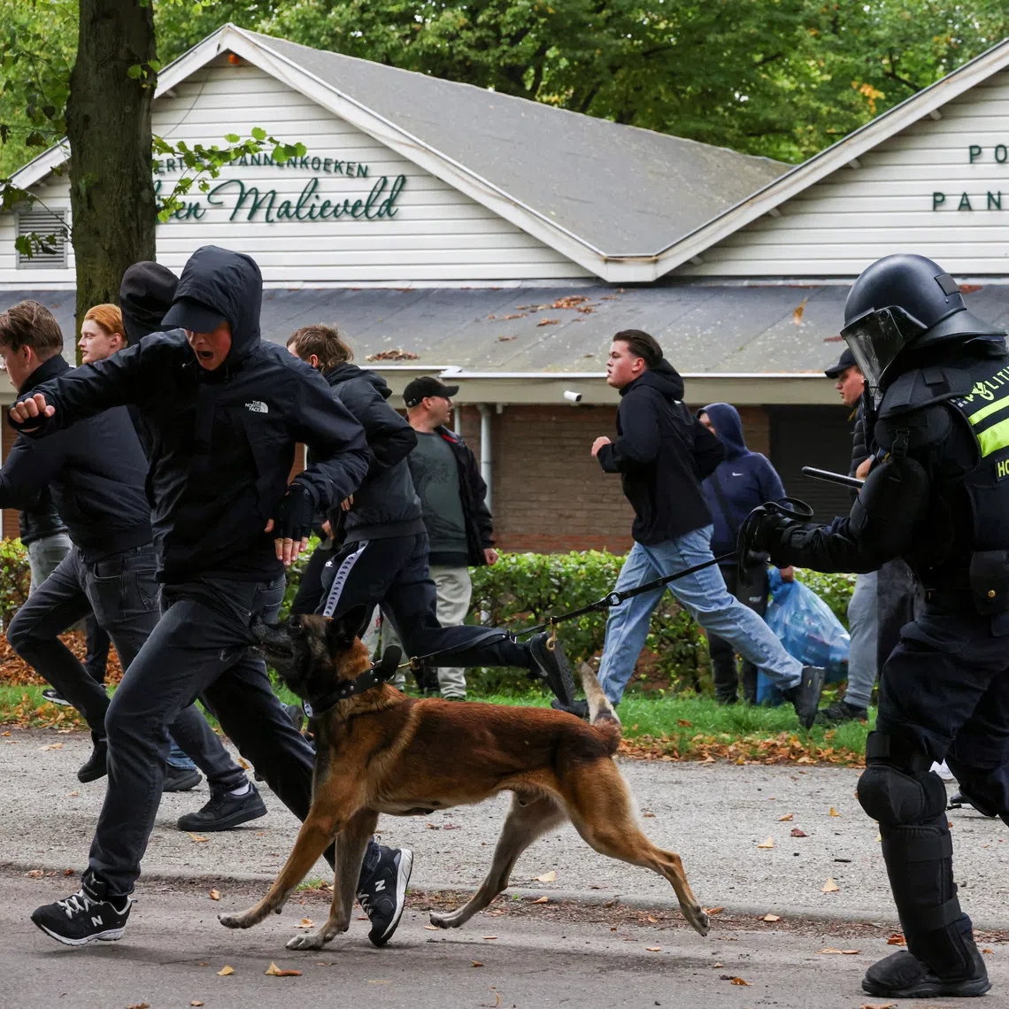 A police dog apprehending a far-right protester in The Hague on Sept 19.