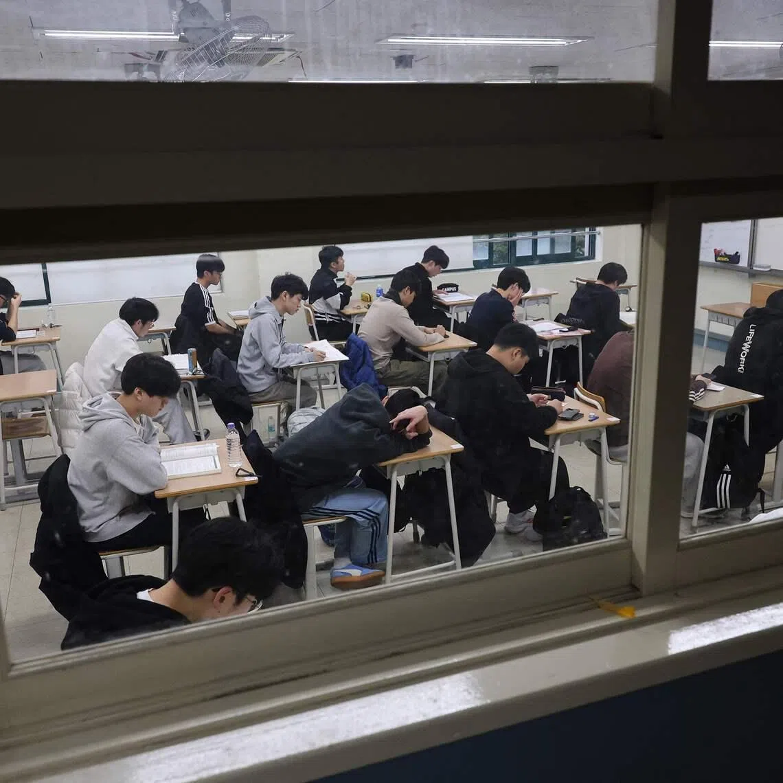 Students wait for the start of the annual college entrance exam, known locally as Suneung, at an exam hall in Seoulon November 13, 2025. (Photo by KIM HONG-JI / POOL / AFP)