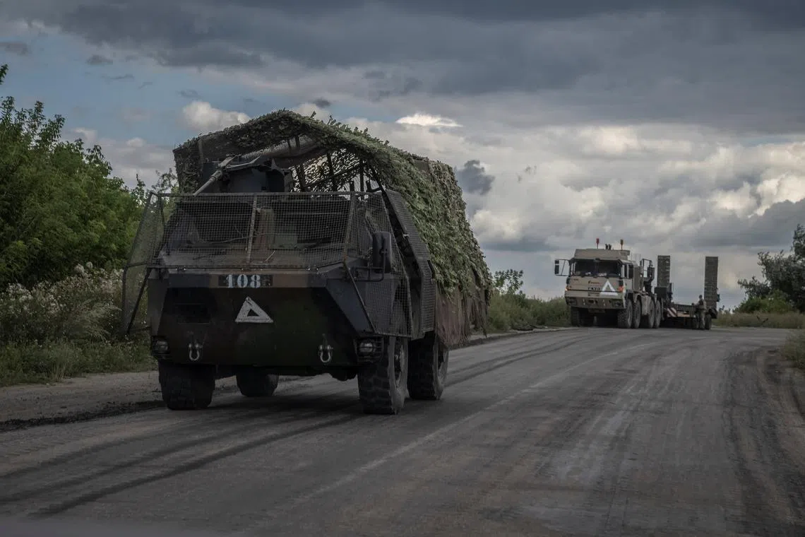 Ukrainian military vehicles are seen at the road, amid Russia's attack on Ukraine, near the Russian border in Sumy region, Ukraine August 11, 2024. REUTERS/Viacheslav Ratynskyi