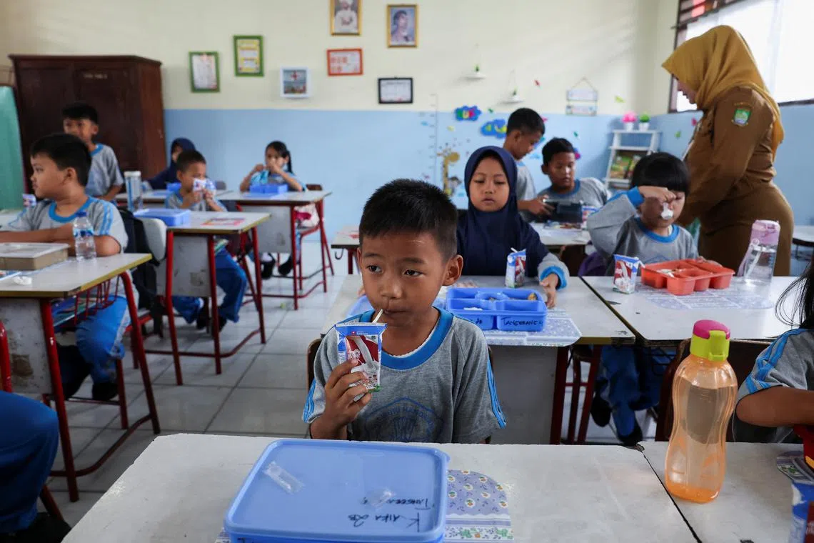 A student drinks a box of milk during a free-lunch programme trial at an elementary school in Tangerang, Indonesia, August 5, 2024. REUTERS/Ajeng Dinar Ulfiana