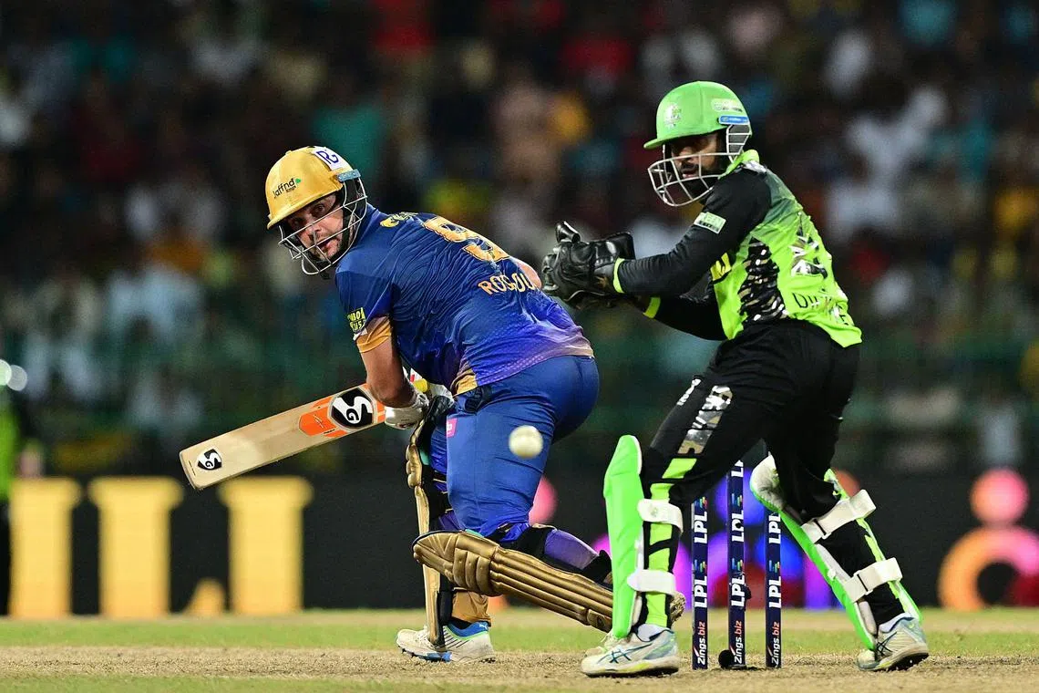Jaffna Kings' Rilee Rossouw plays a shot as Galle Marvels wicket-keeper Niroshan Dickwella looks on in their Lanka Premier League final at the R. Premadasa Stadium in Colombo on July 21, 2024.