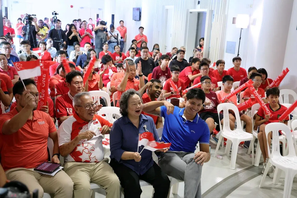 Guests cheering at OCBC Aquatic Centre on Aug 12, after watching a video of Joseph Schooling winning the Rio 2016 Olympics 100m butterfly final. With Schooling are (first row, from left) Singapore Aquatics president Kenneth Goh, Team Singapore’s chef de mission for the Rio Games Low Teo Ping and Schooling’s mother May.