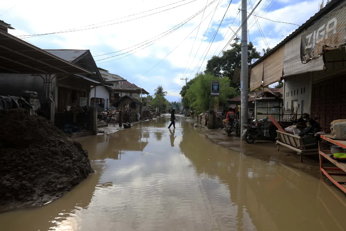 A road is covered in water in a flood-affected village in Indonesia on Dec 2.