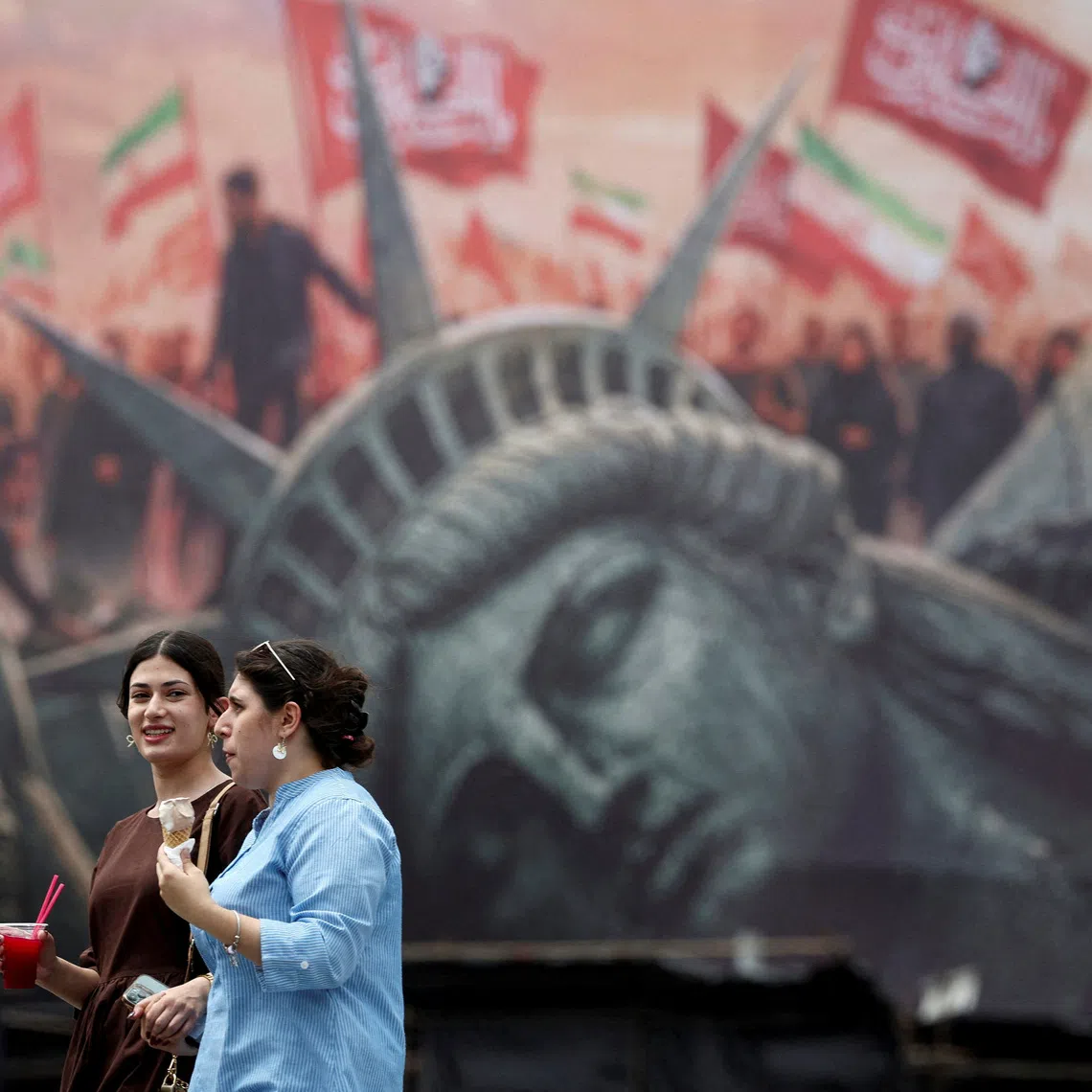 People walk past an anti-U.S. billboard on a street in Tehran, Iran, August 3, 2026. Majid Asgaripour/WANA (West Asia News Agency) via REUTERS
