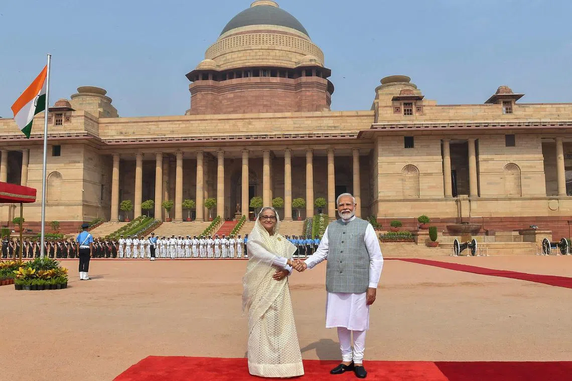 This handout photograph taken and released on June 22, 2024 by the Indian Press Information Bureau (PIB) shows India's Prime Minister Narendra Modi shaking hands with Bangladesh's counterpart Sheikh Hasina (L) after receiving her at the Presidential Palace Rashtrapati Bhavan in New Delhi on June 22, 2024. (Photo by PIB / AFP) / RESTRICTED TO EDITORIAL USE - MANDATORY CREDIT "AFP PHOTO /Indian Press Information Bureau (PIB) " - NO MARKETING NO ADVERTISING CAMPAIGNS - DISTRIBUTED AS A SERVICE TO CLIENTS