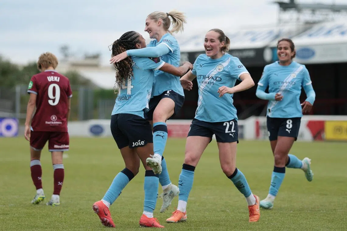 Manchester City's Laura Coombs celebrates scoring their fourth goal against West Ham United with teammates at the Chigwell Construction Stadium in London, on May 16, 2026.