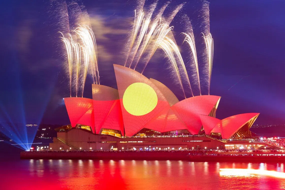 This picture shows the Opera House illuminated in the colours of the Aboriginal flag in Sydney on Australia Day on January 26, 2023.