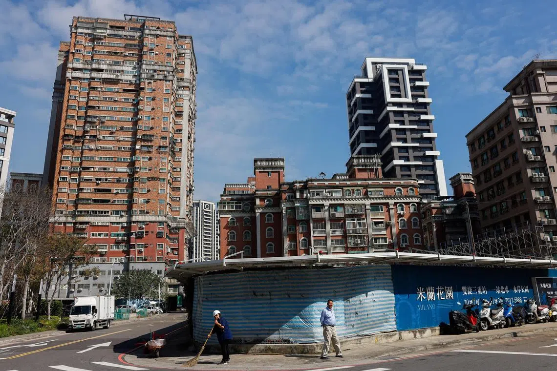 A person cleans the pavements of a construction site in New Taipei City, Taiwan January 31, 2024. REUTERS/Ann Wang