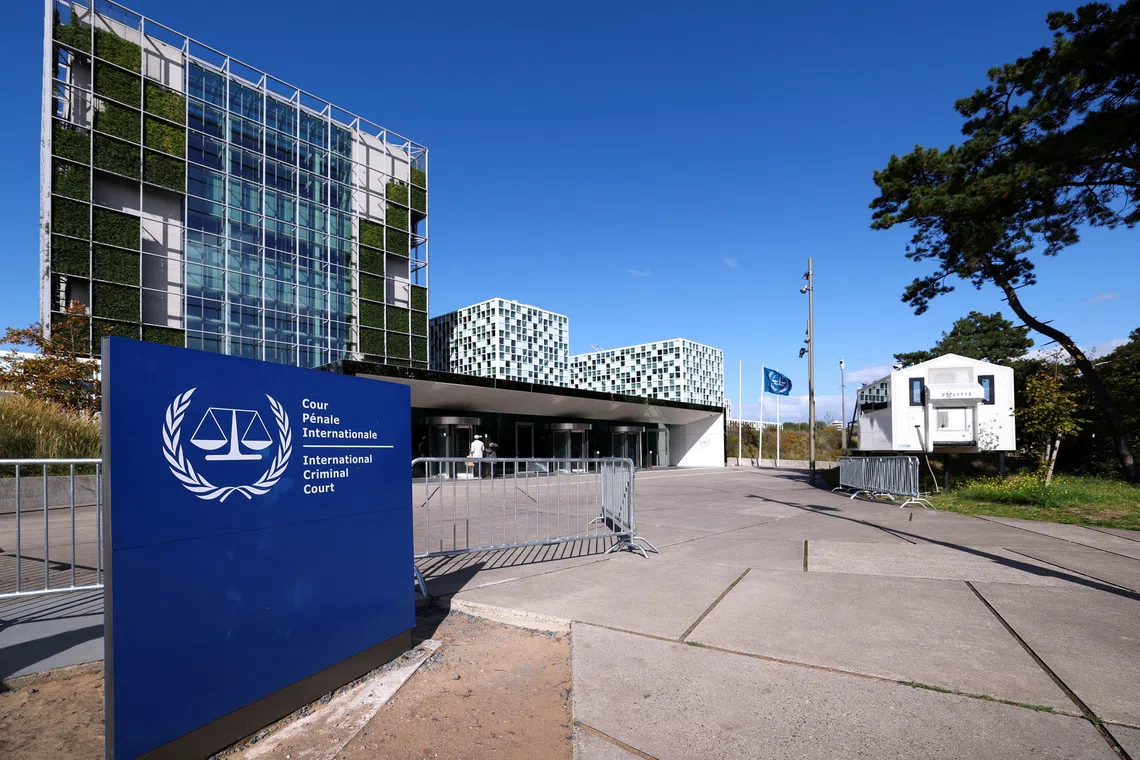 FILE PHOTO: People stand outside the International Criminal Court in The Hague, Netherlands, September 22, 2025. REUTERS/Piroschka van de Wouw/File Photo