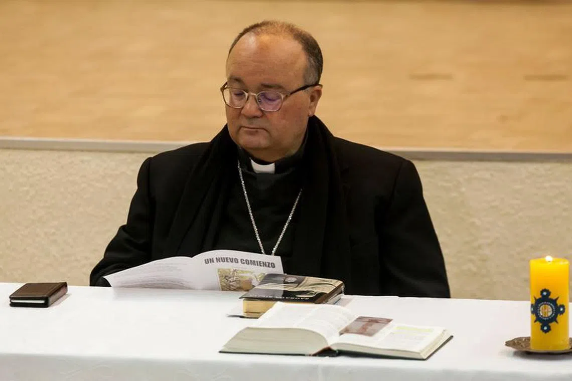 Special Vatican envoys, archbishop Charles Scicluna reads a brochure  entitled \"A new beginning\",  during a meeting with priests inside a church in Osorno, Chile  June 15, 2018. REUTERS/Fernando Lavoz/File Photo