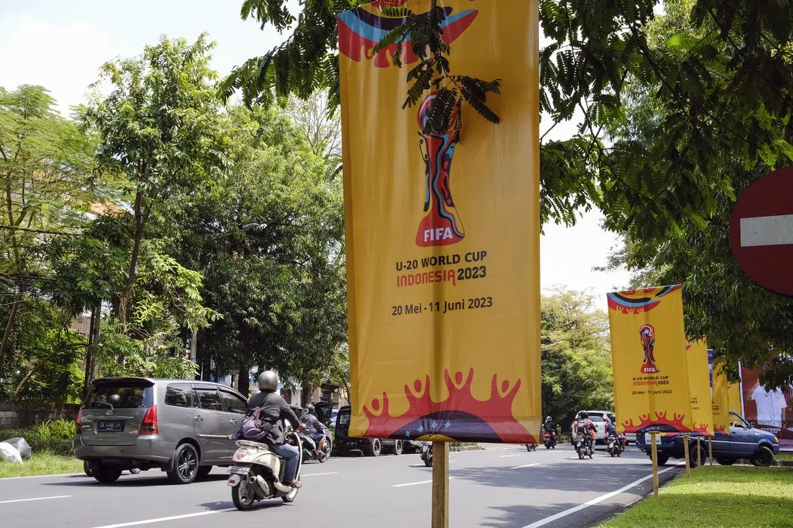 People driving past the banners of Fifa Under-20 World Cup at a main road in Denpasar, Bali, Indonesia. On Wednesday, the Muslim-majority nation has been stripped of its right to host the May 20-June 11 tournament.