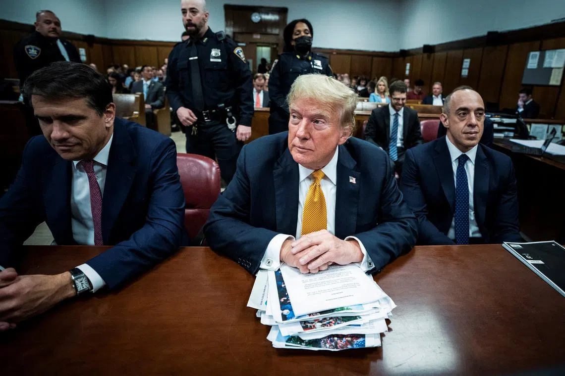 Former U.S. President Donald Trump, flanked by attorneys Todd Blanche and Emil Bove, arrives for his criminal trial at the Manhattan Criminal Court in New York, NY on Wednesday, May 29, 2024. Trump was charged with 34 counts of falsifying business records last year, which prosecutors say was an effort to hide a potential sex scandal, both before and after the 2016 presidential election. Trump is the first former U.S. president to face trial on criminal charges. Jabin Botsford/Pool via REUTERS