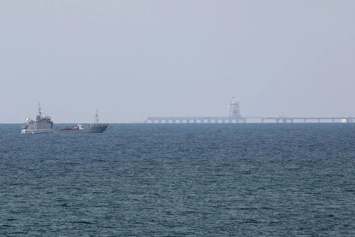 FILE PHOTO: A ship loaded with aid sails near a U.S.-built pier, amid the ongoing conflict between Israel and the Palestinian Islamist group Hamas, as seen from central Gaza Strip, May 18, 2024. REUTERS/Ramadan Abed/File Photo