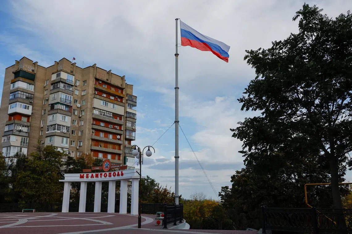 A Russian flag flying in the city of Melitopol in the Zaporizhzhia region, Russian-controlled Ukraine, on Oct 13, 2022. 