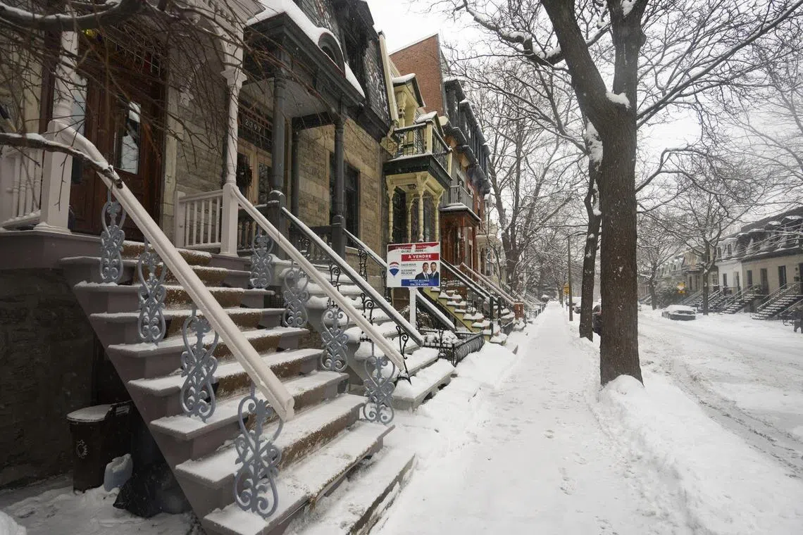 A "For Sale" sign in front of a home in Montreal, Quebec, Canada, on Wednesday, Dec. 28, 2022. Canadian home prices fell for a ninth straight month as sharply rising interest rates prompted buyers and sellers to withdraw from the market heading into the traditionally slower winter season. Photographer: Christinne Muschi/Bloomberg