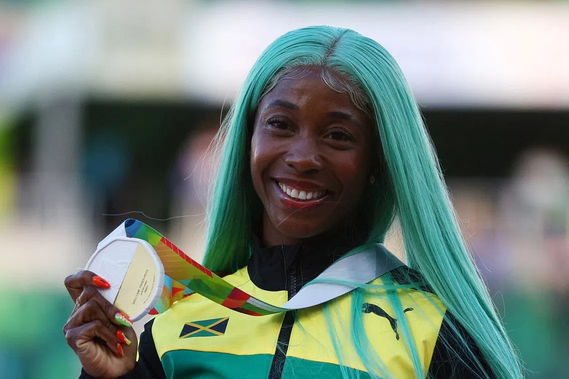 FILE PHOTO: Athletics - World Athletics Championships - Women's 100 Metres - Final - Hayward Field, Eugene, Oregon, U.S. - July 18, 2022 Gold Medallist Jamaica's Shelly-Ann Fraser-Pryce celebrates on the podium during the medal ceremony REUTERS/Brian Snyder/File Photo