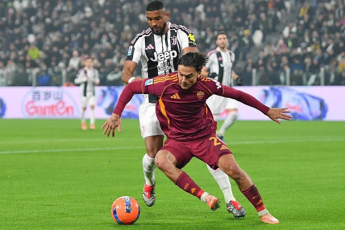 Juventus' Gleison Bremer closing down Roma's Paulo Dybala in their Italian Serie A soccer match between at the Allianz Stadium in Turin on Dec 20, 2025.