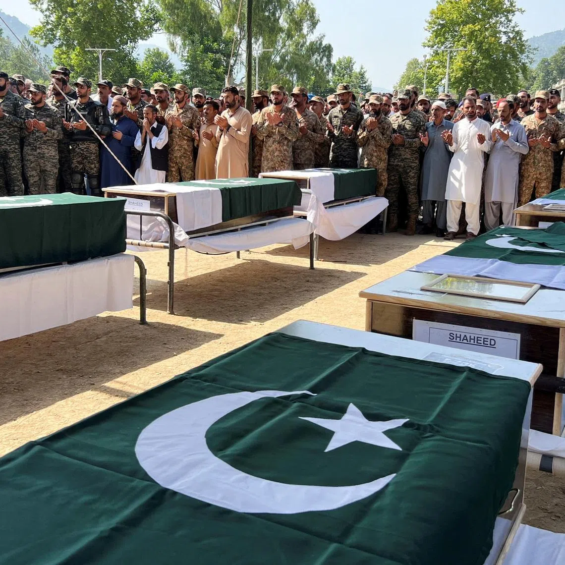 Pakistani Army officers and people offer prayers as they attend the funeral of the victims, who died after an Mi-17 helicopter of Pakistan Army Aviation crashed near Muzaffarabad on Wednesday during take-off, in Muzaffarabad, Pakistani Kashmir, June 11, 2026. Picture taken with a mobile phone. REUTERS/Naseer ud Din
