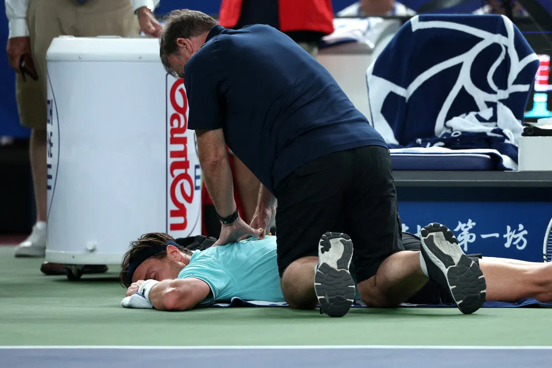 Tennis - ATP Masters 1000 - Shanghai Masters - Qizhong Forest Sports City Arena, Shanghai, China - October 12, 2025 France's Arthur Rinderknech receives medical attention during the final against Monaco's Valentin Vacherot REUTERS/Go Nakamura