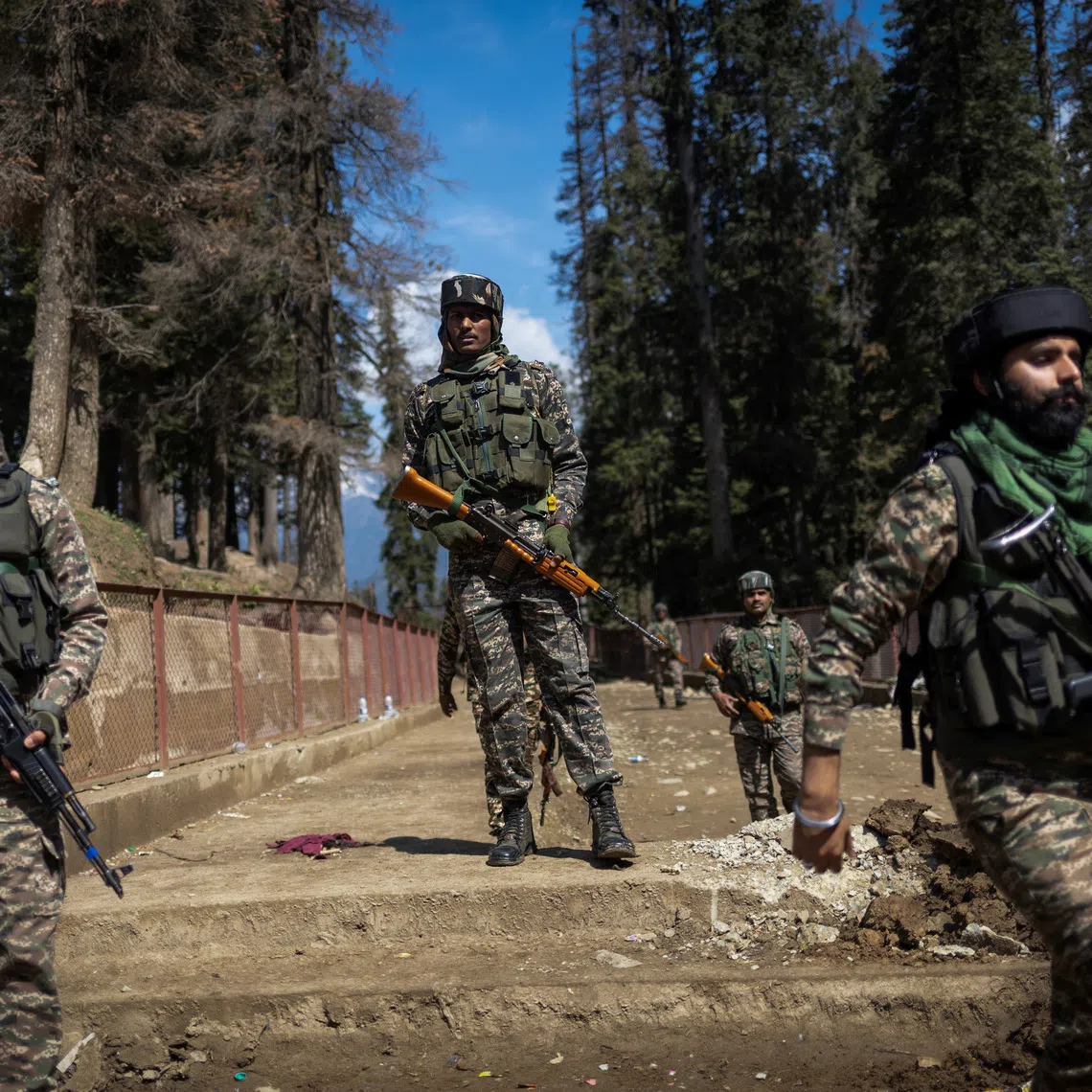 Indian security force personnel stand guard at the site of a suspected militant attack on tourists in Baisaran near Pahalgam in south Kashmir's Anantnag district, on April 24, 2025.