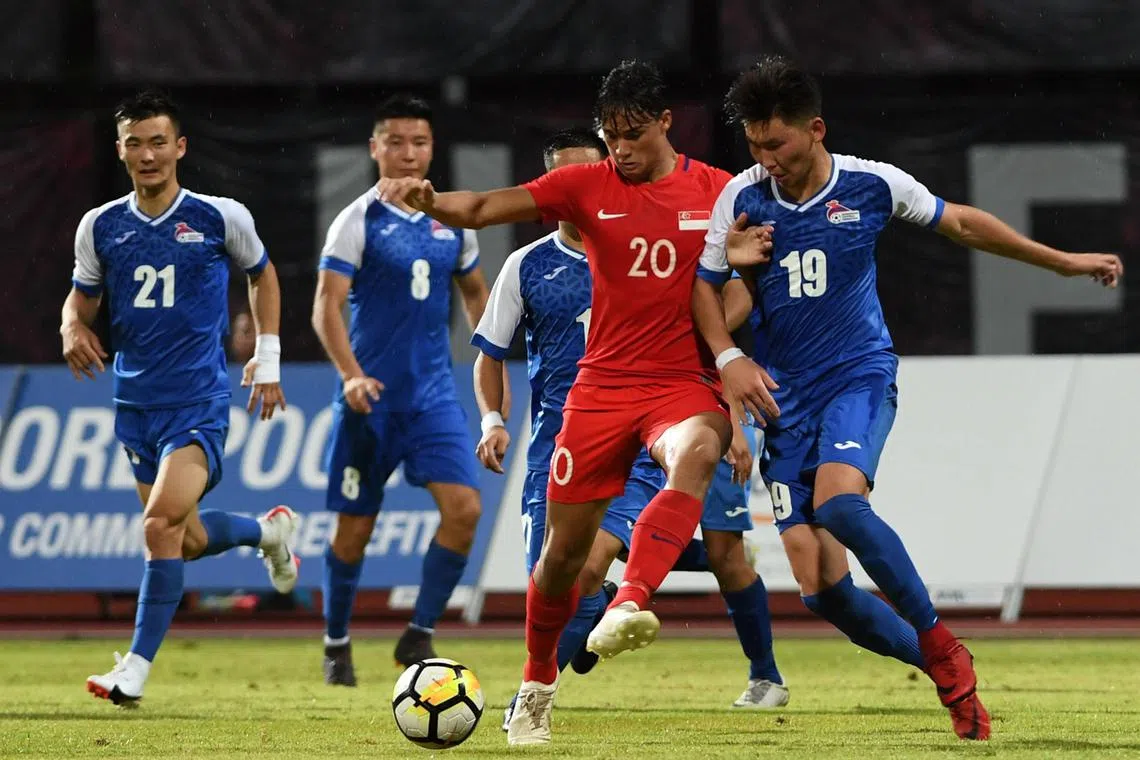 The Mongolian national football team (in blue) in action during a friendly against Singapore. Mongolia will face Afghanistan in a World Cup qualifier in Tajikistan on Thursday.