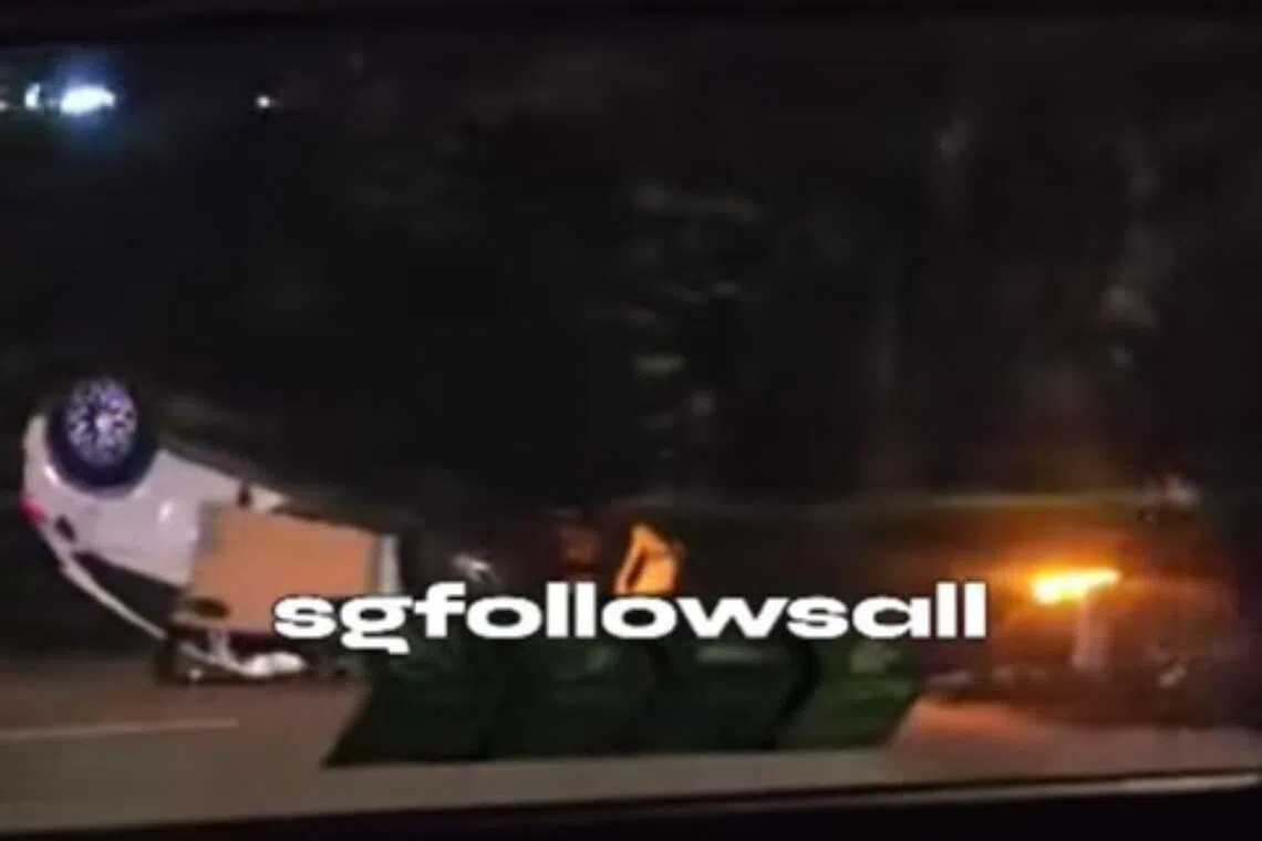 In a video shared online, a white car can be seen turned turtle on the expressway with its front cabin damaged.