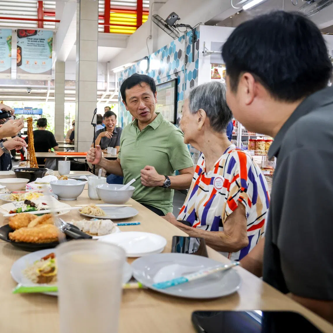 Health Minister Ong Ye Kung (in green shirt) and Bishan-Toa Payoh GRC MP Cai Yinzhou (in blue shirt) interacting with residents during a community visit to Toa Payoh Central on May 9.