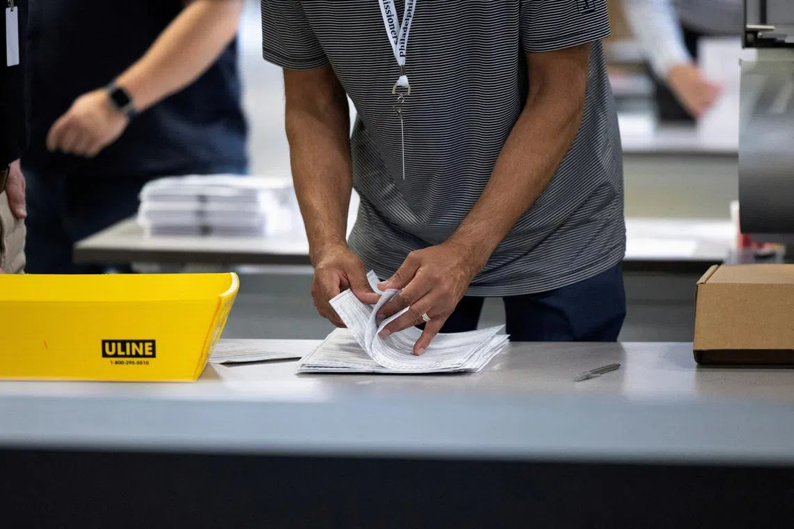 FILE PHOTO: An election worker processes ballots at Philadelphia's vote counting facility on Pennsylvania's primary election day in Philadelphia, Pennsylvania, U.S. April 23, 2024.  REUTERS/Rachel Wisniewski/File Photo